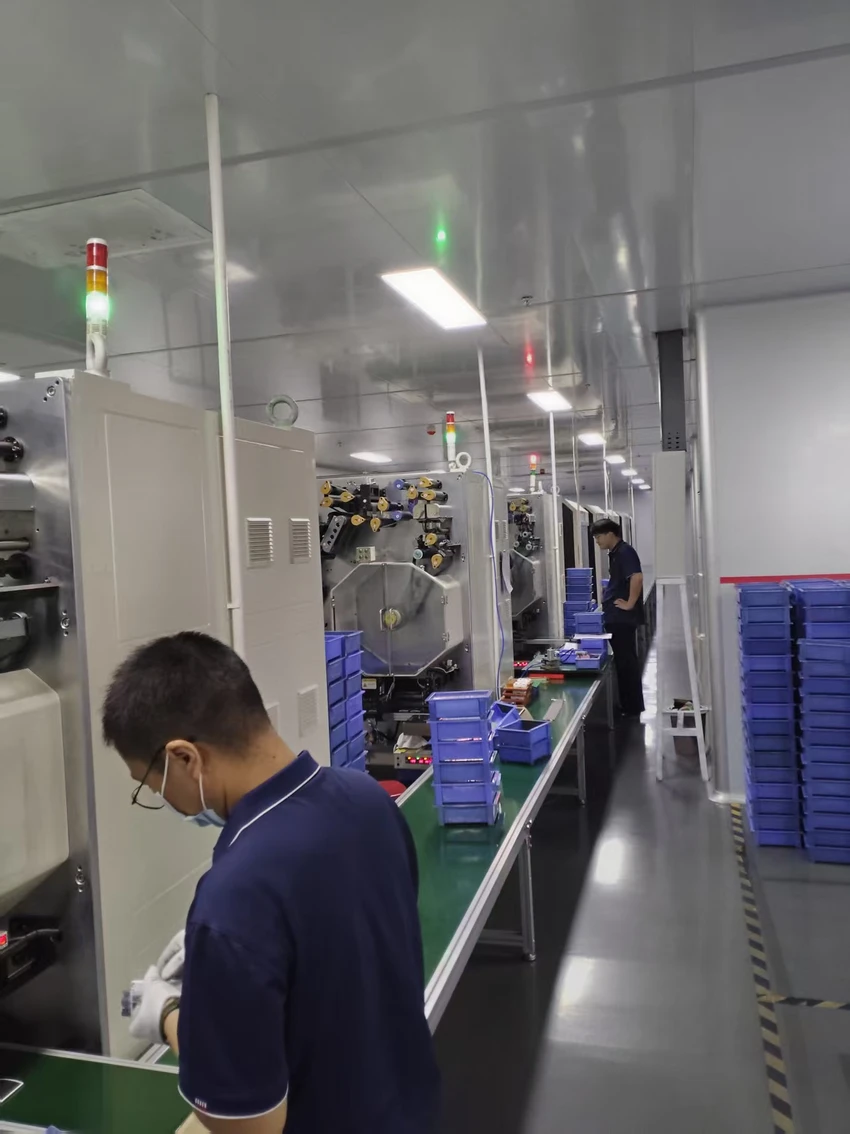 Operator beside battery production equipment