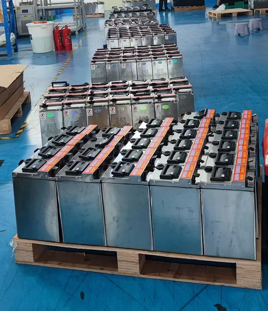 Supplied workshop photograph of battery enclosures with handles arranged for handling